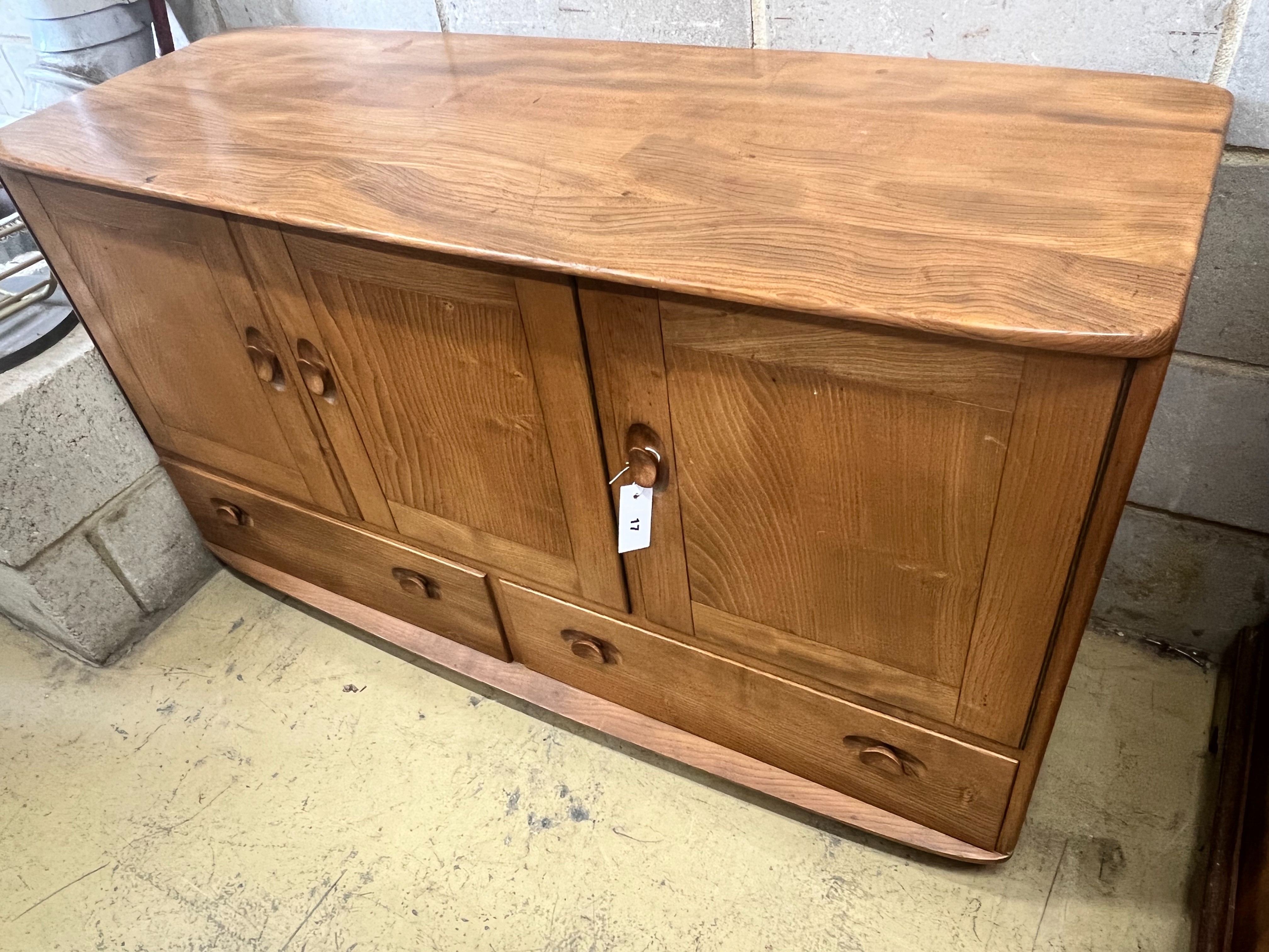 An Ercol honeydew elm sideboard, width 129cm depth 49cm height 6cm